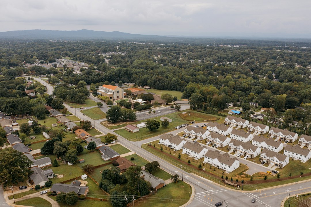 Aerial view of a residential neighborhood with homes and mature trees