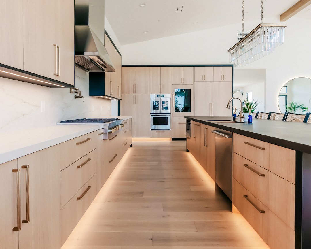 Custom kitchen with flat-panel wood cabinets, a large island and black-framed windows