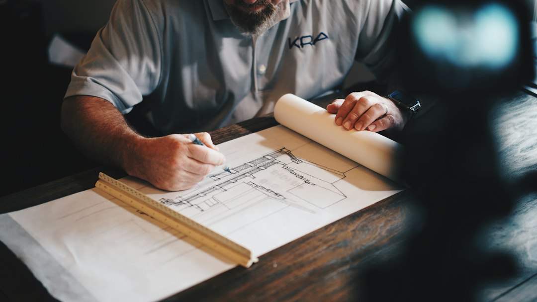 House plans and drafting tools spread across a table
